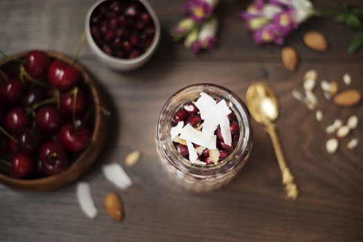 Overnight Chia Pudding With Chia Seeds, Oats, Pomegranate And Coconut Chips. Healthy Breakfast Concept. Dark Background. Healthy Lifestyle Concept. Copy Space