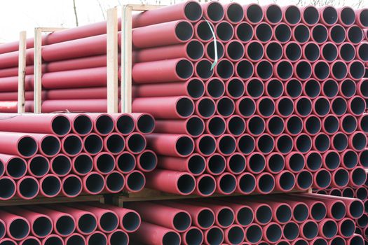 Stockyard of various tubes and pipes at a construction site.