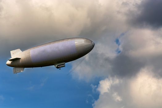 Airship, zeppelin against blue sky with dark clouds.