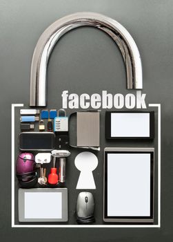 Facebook, with various devices including tablets, computer mouse, usb cards in the shape of a padlock on a chalkboard background