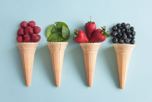 Four icecream cones with natural ingredients including berries, and mint flavors