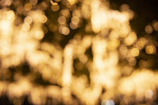 Close up of large golden bokeh shapes.