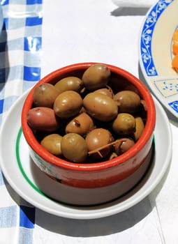 container with green olives