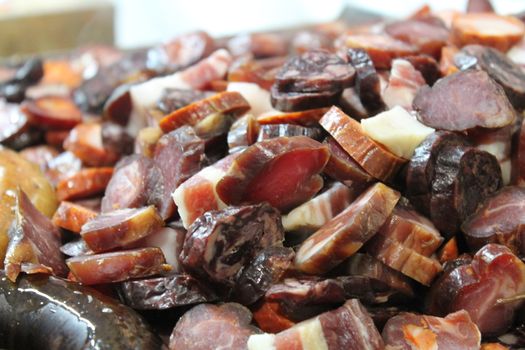 roast meat on plate with sausages and steaks