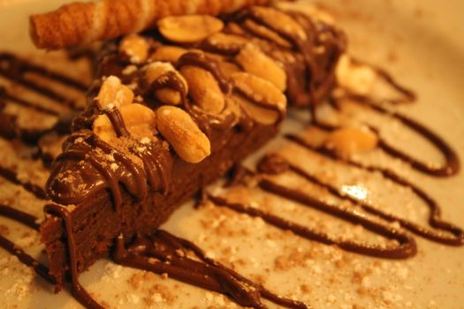 Chocolate cake with peanuts and topping