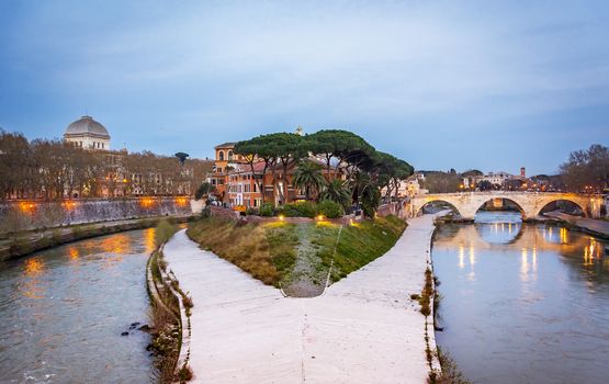 The historical Tiber island from the Garibaldi Bridge in Rome.