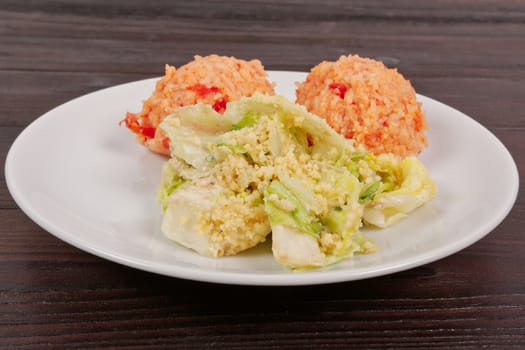 Tomato rice and salad on a wooden table