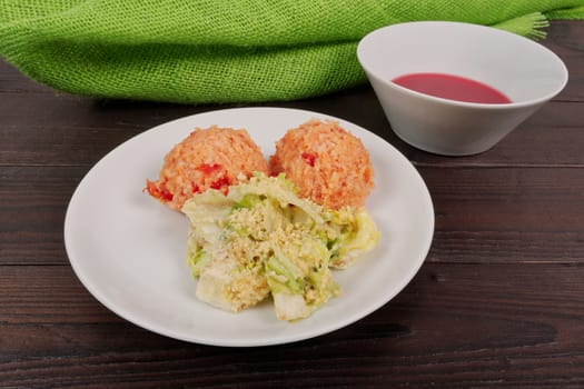 Tomato rice and salad on a wooden table