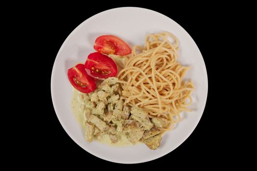 Spaghetti with tempeh and herb sauce on a black background