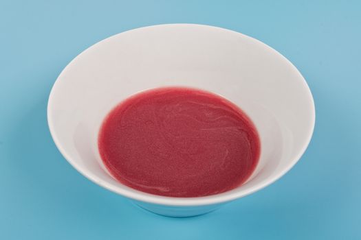 Beet soup with wine on a blue background