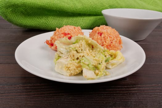 Tomato rice and salad on a wooden table