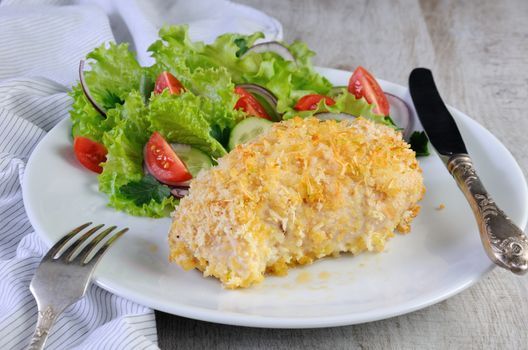 Baked to a golden, crispy crust chicken roll in breadcrumbs with parmesan and garnish of vegetables.