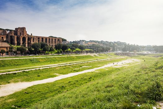 Wide view of the remains of the Circus Maximus of Rome with the ruins of the Domus Severiana in the background
