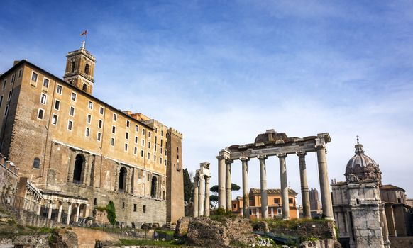 view of the Roman Forums with the backside of the Campidoglio Senatorial Palace and the ruins of a Roman temple with marble columns