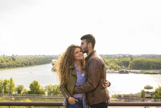 Attractive lovers enjoying the time near the river