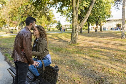 Attractive and modern lovers showing sweetest emotions in the public park