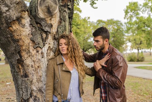 Beautiful long haired woman feeling disappointed and ignoring his boyfriend while he is trying to solve relationship problems