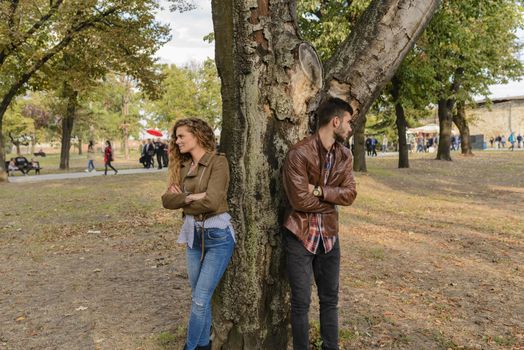 Attractive and modern lovers ignoring each other after relationship conflict.