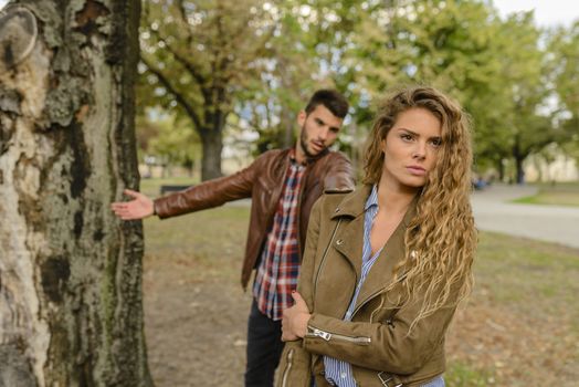 Betrayal and break up in relationship. Disappointed man arguing with his girlfriend while she is ignoring him.