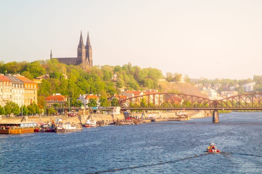 Vysehrad and Railroad Bridge over Vltava on sunny summer evening with sunset. Prague cityscape, Czech Republic.