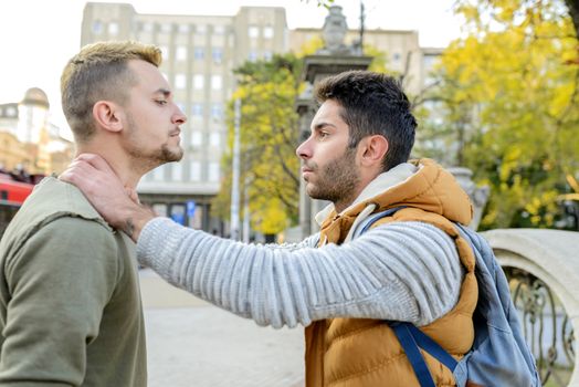 Two friends having a debate in the city street