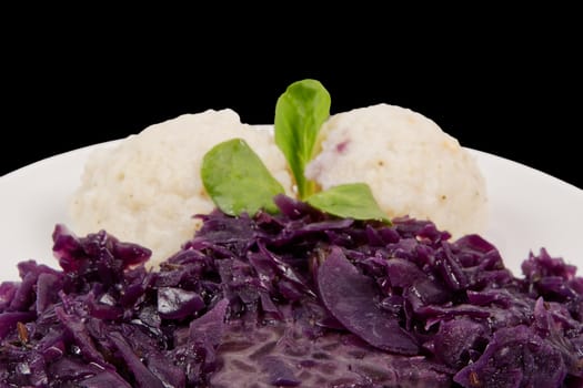 Tempeh with red cabbage and sorghum on a black background