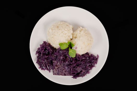 Tempeh with red cabbage and sorghum on a black background