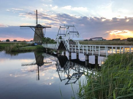 Beautiful dutch windmill landscape at the famous Kinderdijk canals, UNESCO world heritage site