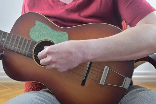 Close up of guitarist hand playing acoustic guitar. Musical concept.