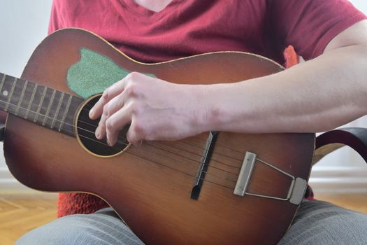 Man playing on acoustic guitar. Musical concept. Close-up