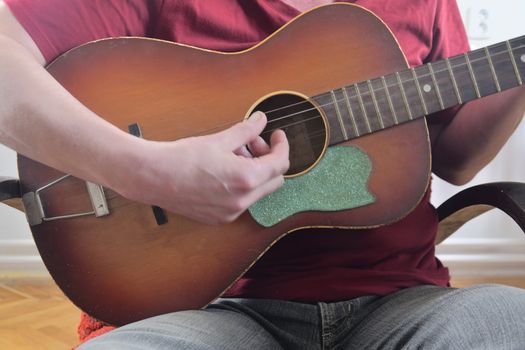 Man playing on acoustic guitar. Musical concept.