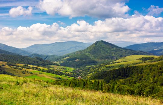 Abranka village in the valley of Carpathian mountains, Ukraine. lovely countryside scenery in early autumn with clouds distant ridge.