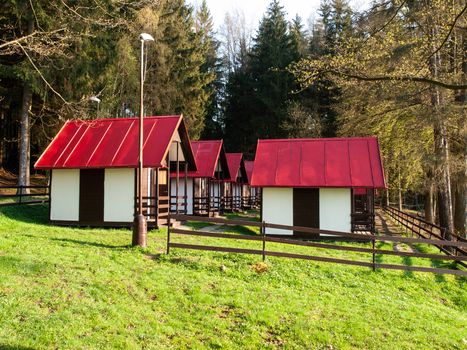 Small wooden forest cottages at the water.