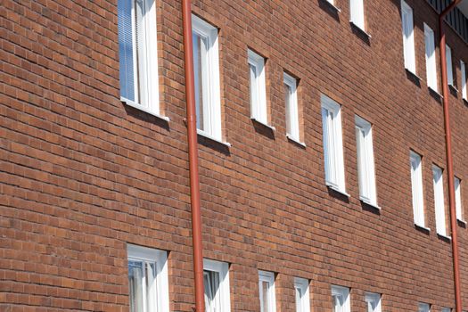 Apartmend building with Windows and bricked wall.