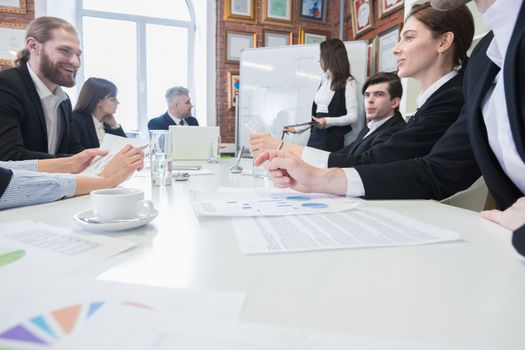 Business partners discussing documents and ideas at meeting