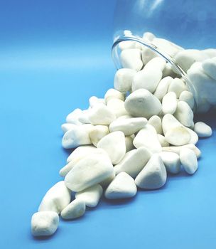 white stones and glass bowl spa relax concept  isolated on blue background perspective