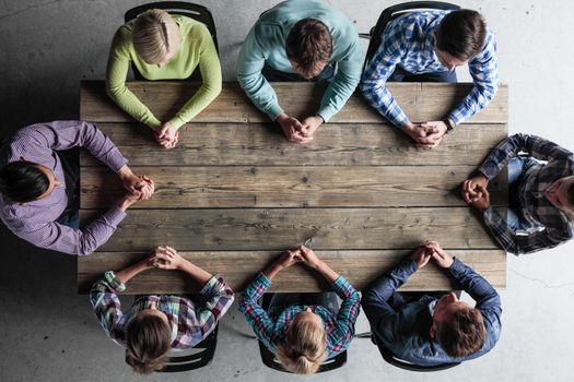 Modern business meeting concept, people in casual clothes sitting around wooden table