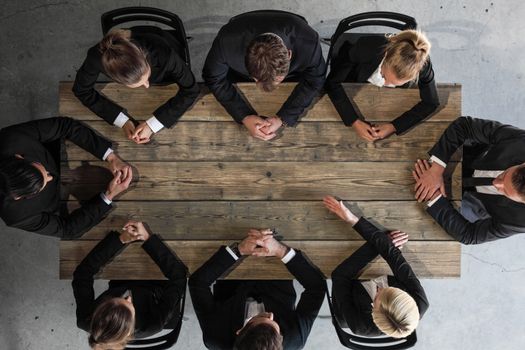 Business meeting concept, people in formal wear sitting around wooden table