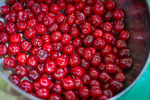 Sweet red Cherry in Bowl on Table top close-up view