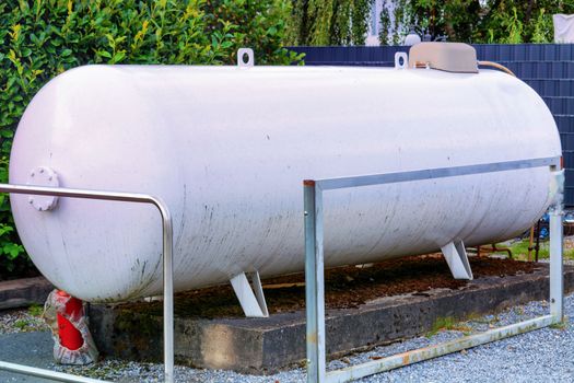 Large propane gas tank or liquid gas tank in a garden.