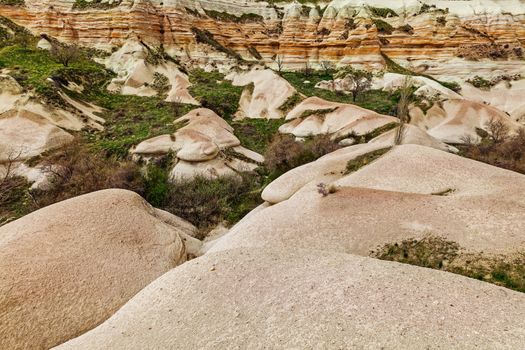 Stone cliffs look like mushrooms in valley near Goreme, Cappadocia, Turkey