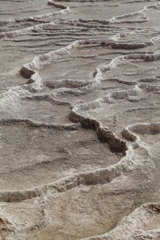 Relieved lines and patterns created in process of drying water with high amount of travertine.
