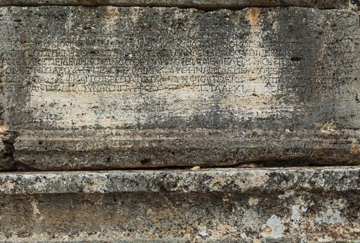 Texture of stone plate with inscriptions in ancient city Hierapolis near Pamukkale, Turkey