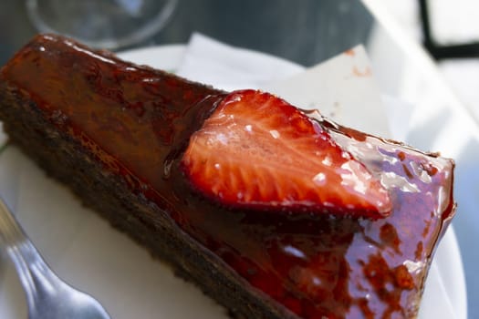 Chocolate cake with strawberries sliced strawberries and topping