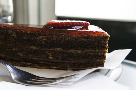 Chocolate cake with strawberries sliced strawberries and topping