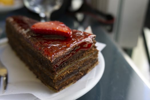 Chocolate cake with strawberries sliced strawberries and topping