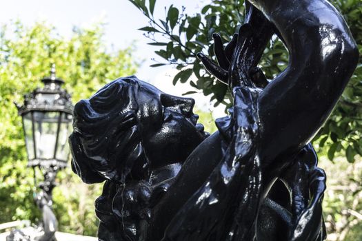 Carved steel statue of black color with the face of a Venus woman in lisbon