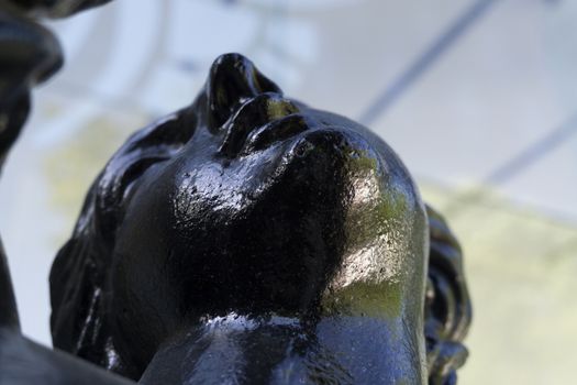 Carved steel statue of black color with the face of a Venus woman in lisbon