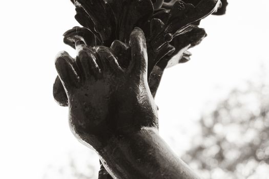 Detail on metal statue black . Hands detail