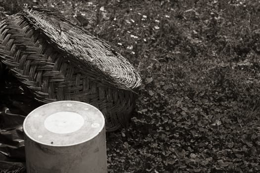 sepia effect Braided hemp basket resting on the ground